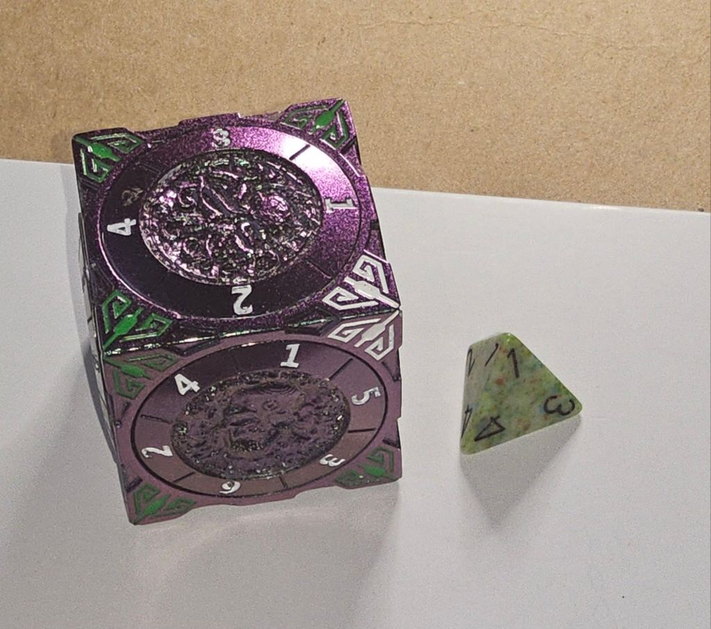 7-in-1 dice cube showing 4-sided & 6-sided spinner discs and 4-sided polyhedral die. Gaming dice. 