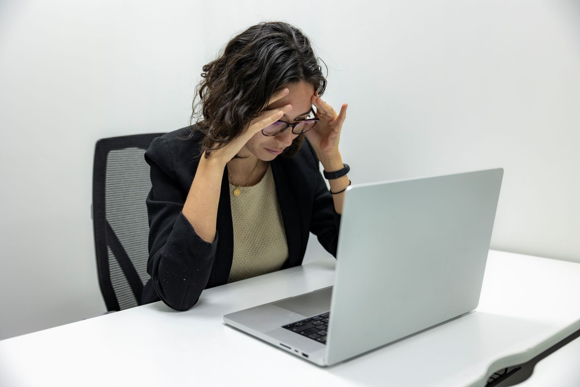 Woman with a headache at work.