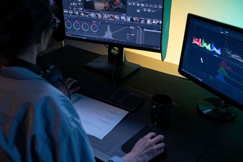 Man working on computer using editing software.